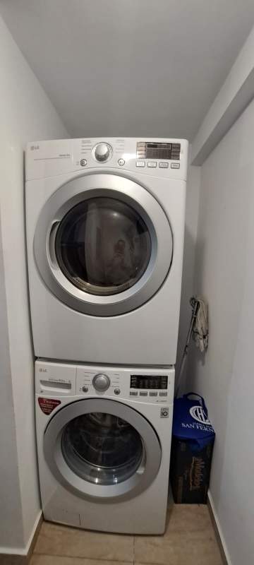 Laundry nook featuring stacked LG washer dryer PH Terrazas del Rey apartment Condado del Rey Panama