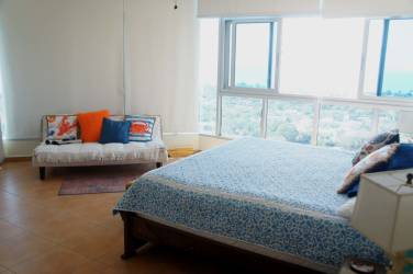 Bright master bedroom with ocean view windows and modern furnishings in PH Coronado Golf Panama