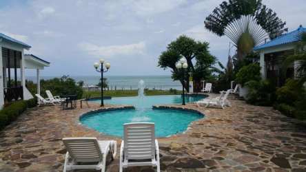 Tropical garden landscape with pool and ocean view at Costa Grande Beachfront Cabins Nueva Gorgona