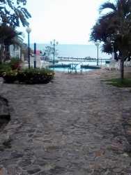 Swimming pools with palm trees next to the ocean Costa Grande Beach Residences Nueva Gorgona Panama