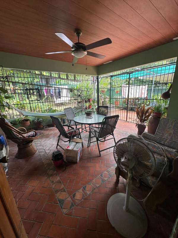 Covered balcony area with terracotta tiles and railings on commercial house Betania Panama