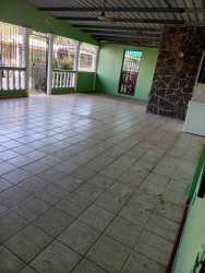 Enclosed patio with tiled floor, stone accent wall, and windows secured by bars in Panama apartment