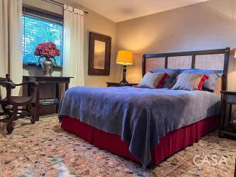 Traditional interior with open living dining looking out at covered terraces Volcán estate