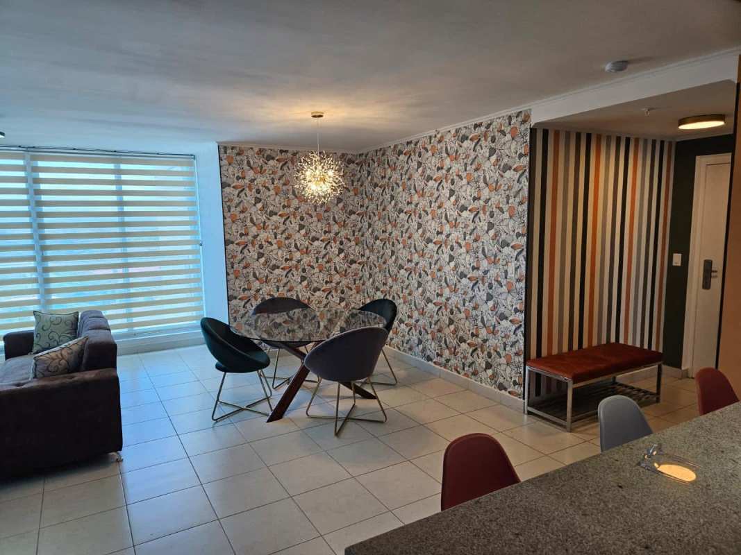Living dining area connected to balcony with zebra blinds in PH Miro Panama City