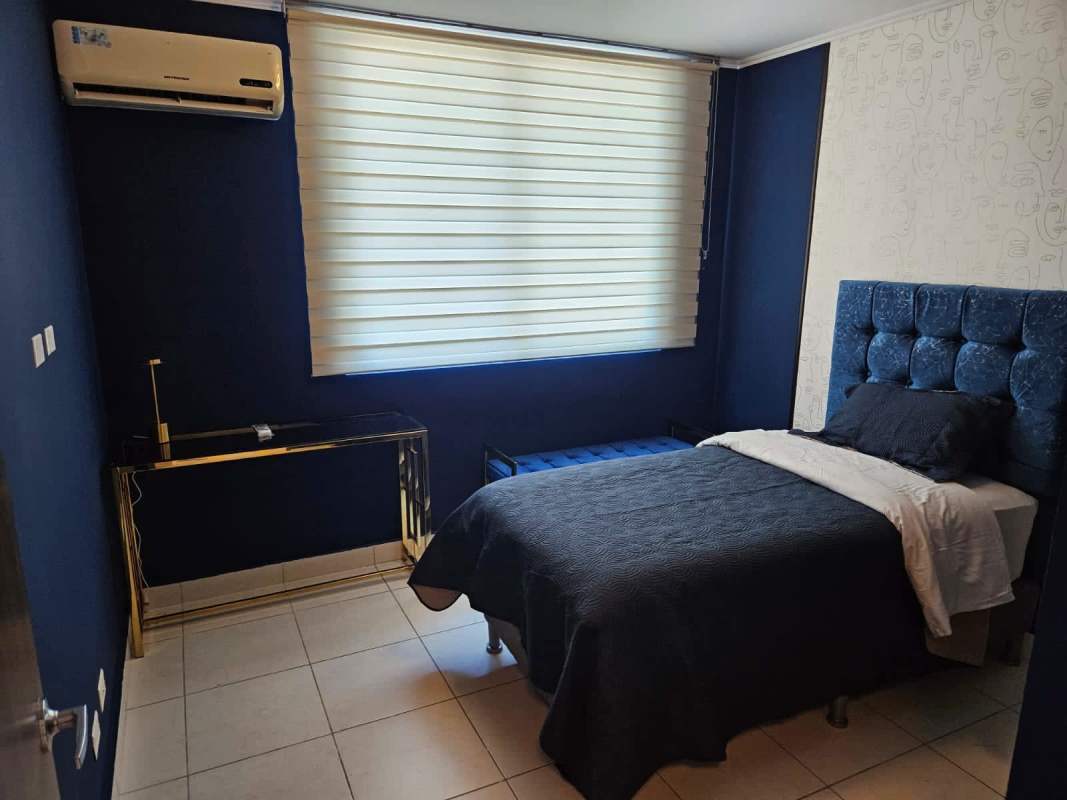 Modern bedroom navy accent wall gold desk large window blinds PH Miro El Cangrejo