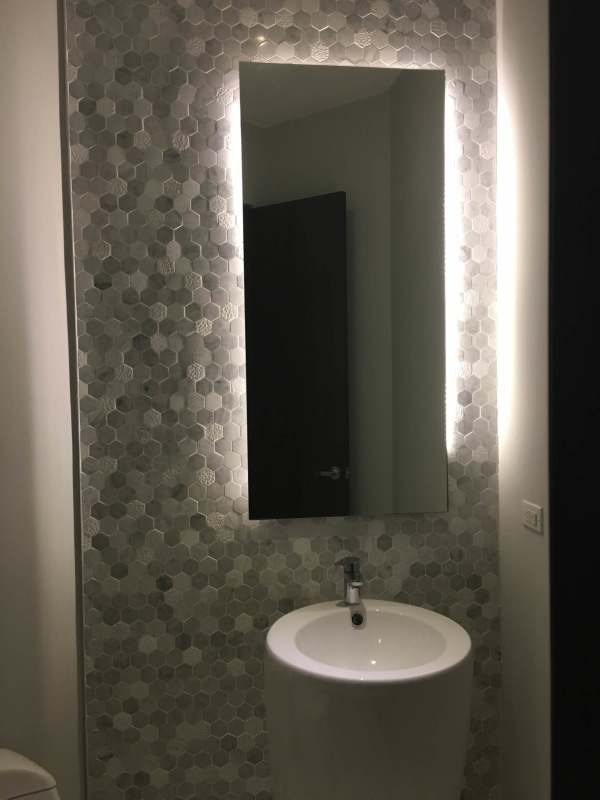 Infinity pool and tennis court with ocean backdrop at PH Castellammare Costa del Este Panama