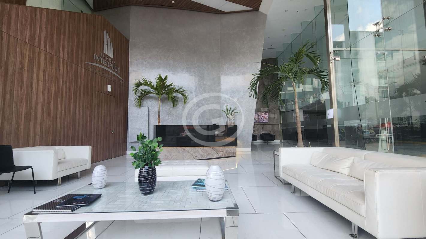 Elegant lobby with glass walls, white sofas, reception desk at Balboa Office Center Panama