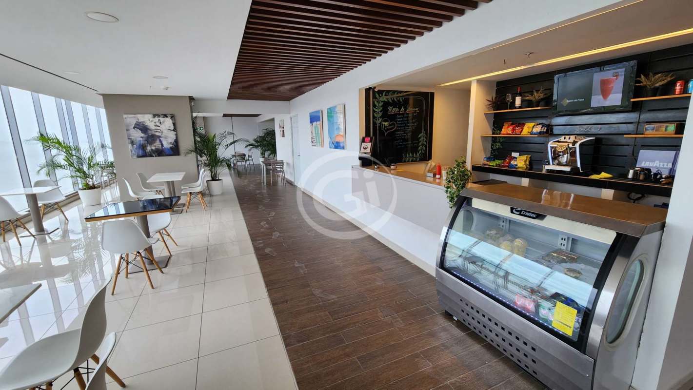 Modern café lounge inside PH Balboa Office Center with large windows and snack bar