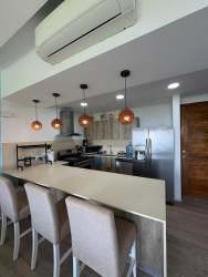 Bright furnished living room with ocean view at Punta Caelo beachfront apartment Panama