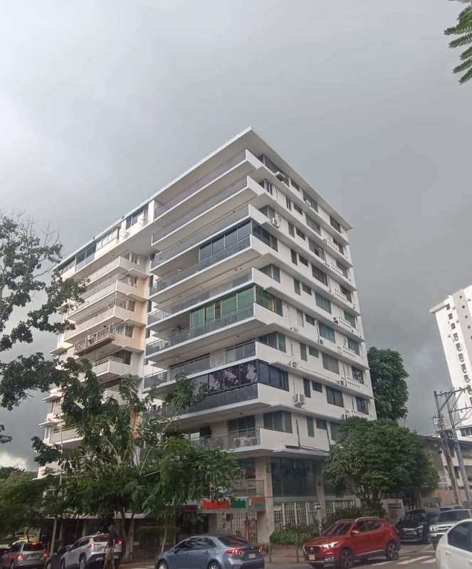 Multi-story apartment building exterior with multiple balconies and retail stores on Vía Argentina Panama