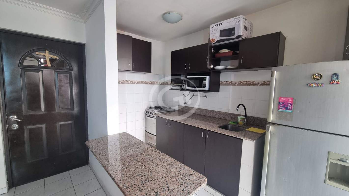 Compact modern kitchen with granite countertops, microwave, gas stove, fridge, breakfast counter PH Torres Bella Vista
