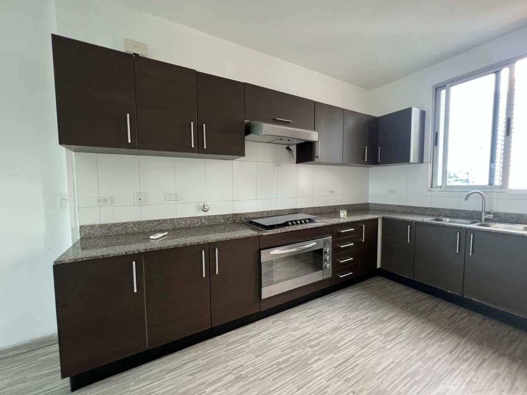 Open plan living and dining space with vinyl wood flooring and balcony access in PH Galeria Uno Panama City