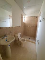 Bathroom with beige tiles, shower area and sink in Los Avellanos Panama