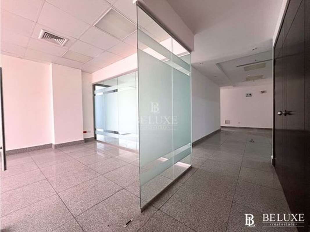 Glass-walled office cubicles in modern commercial building Obarrio Panama