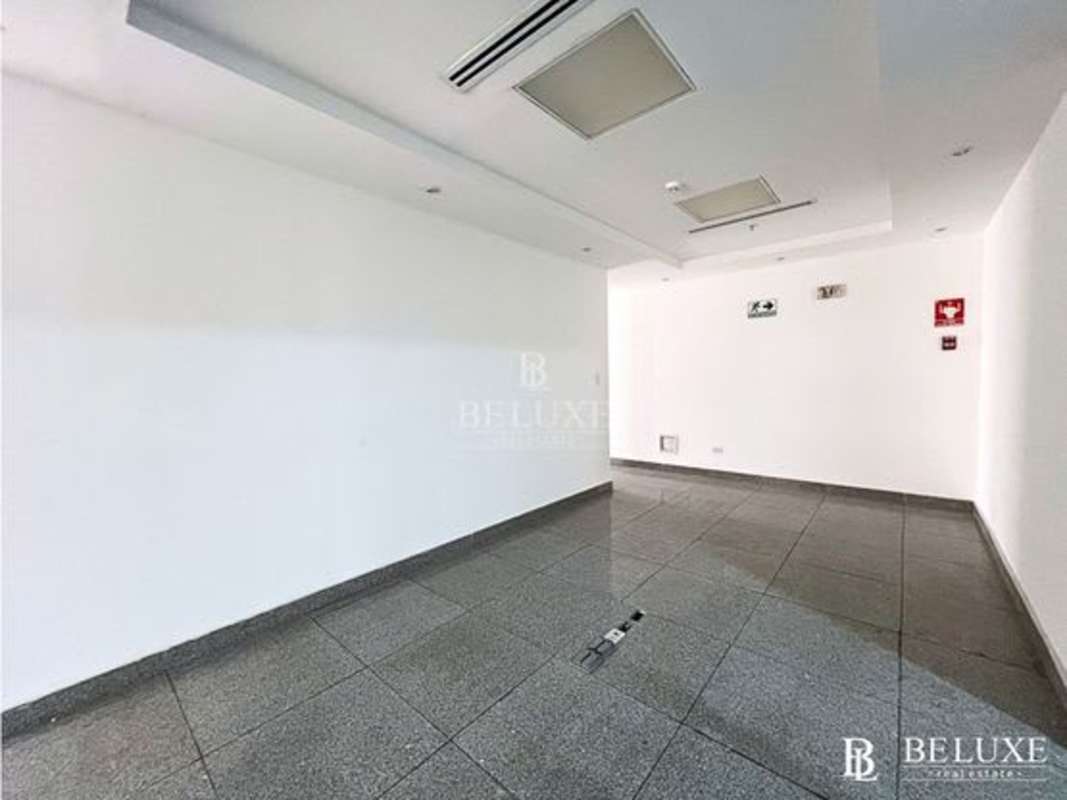 Open office with recessed lighting tiled floors fire safety features in SFC Tower Obarrio