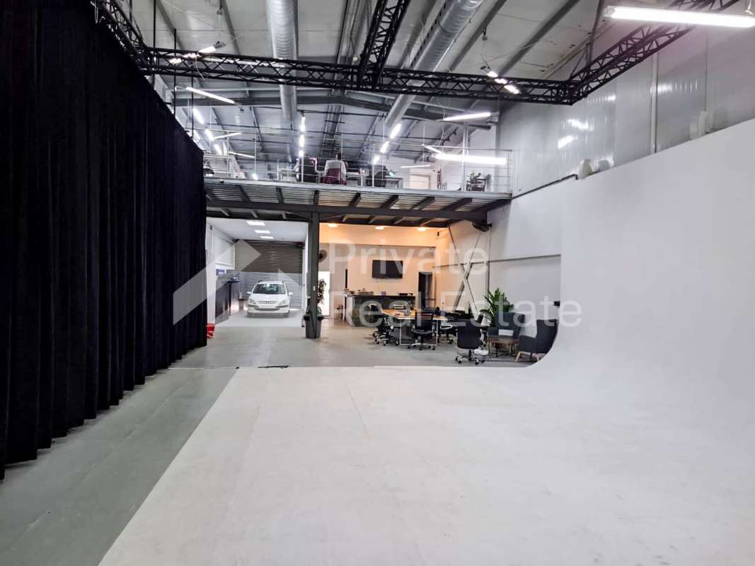 Modern balcony space with metal chairs, glass railing, overlooking neighborhood Panama City