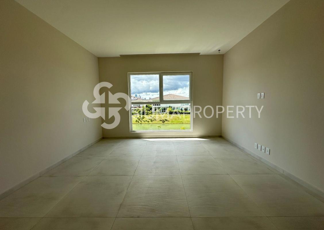 Bright living room with full-height windows facing garden in Santa María luxury home Panama City