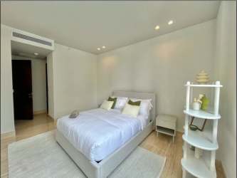 Spacious master bedroom with ocean facing floor-to-ceiling windows in The Towers Punta Paitilla Panama