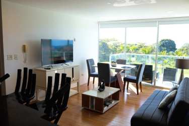 Kitchen with granite counters, breakfast bar, appliances in Bala Beach Resort apartment Panama