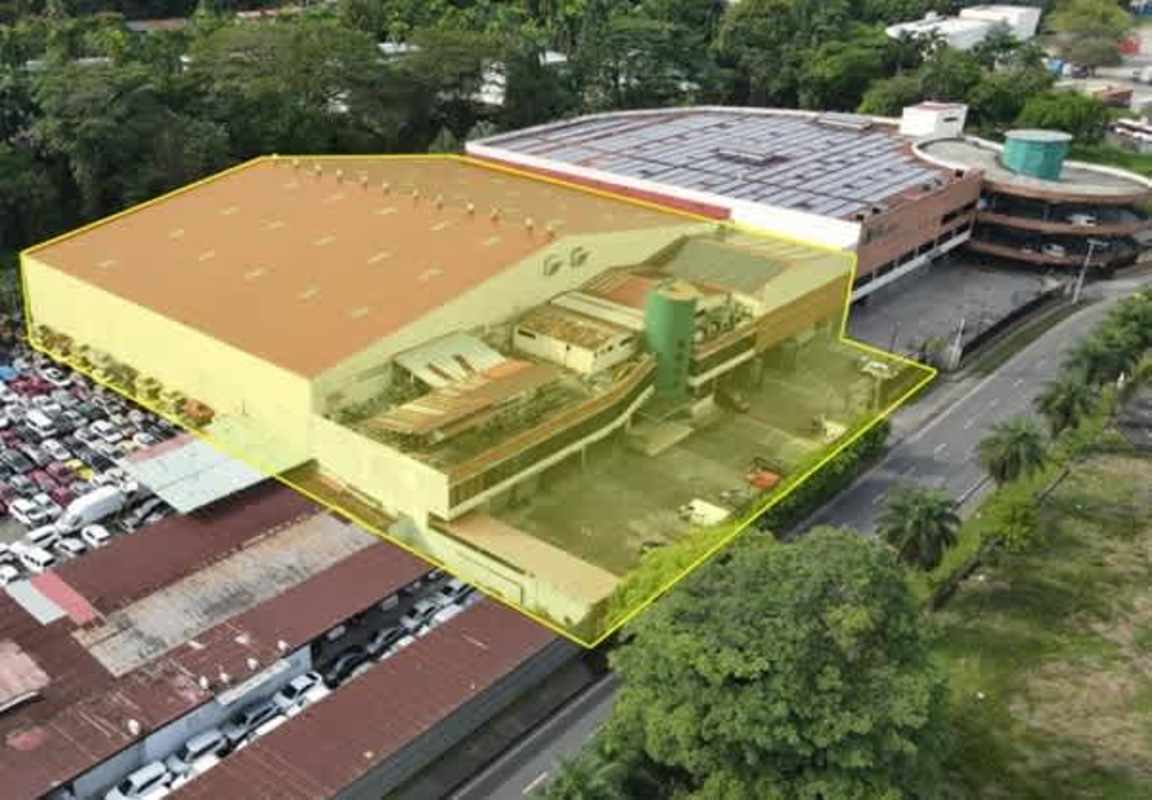Modern multi-story commercial building exterior with parking Curundu Panama
