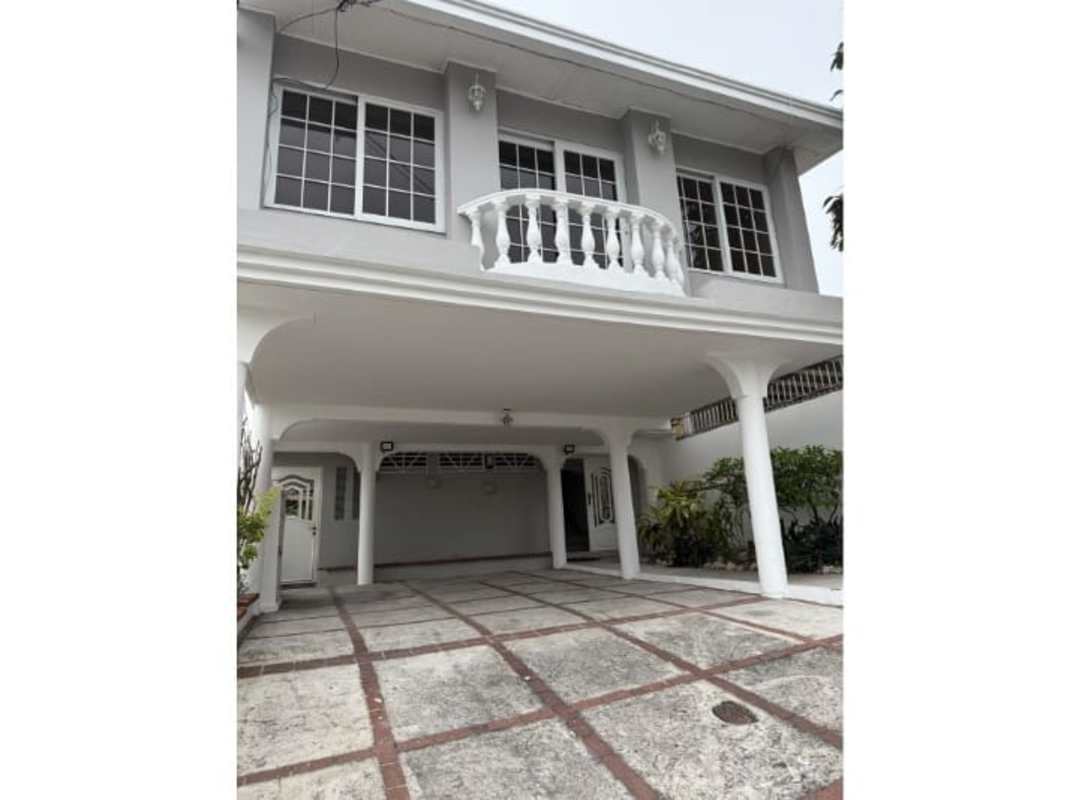 Front exterior showing covered parking, balcony, columns, and driveway Club X Betania Panama