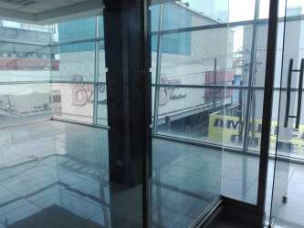 Glass wall enclosed office panoramic city view marble floors Zona Libre Colón Panama