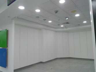 Spacious empty unit tiled floors drop ceiling recessed lighting in trade zone Colón