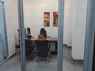 Glass partition executive office modern finishes Colón Free Zone commercial tower Panama