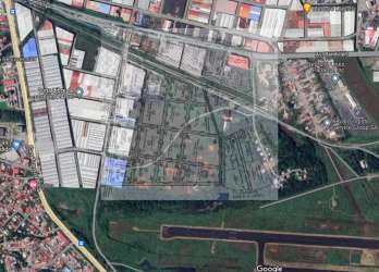 Aerial view showing logistics facilities, free zone lots, and adjacent Enrique Jiménez International Airport