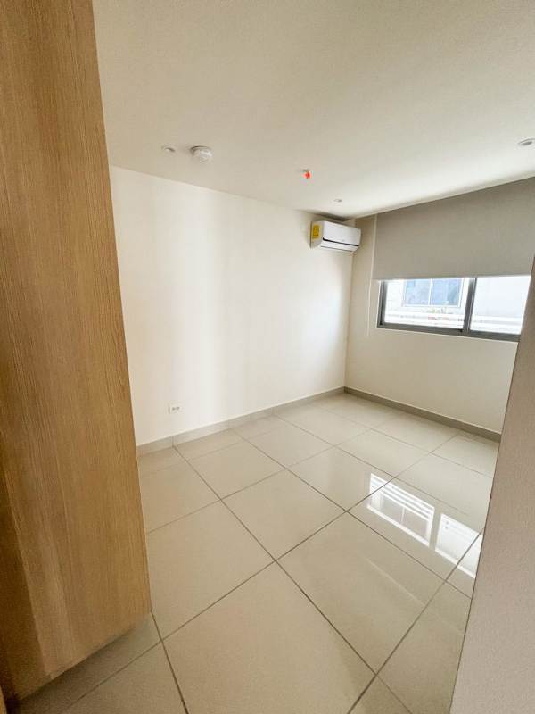 Bright apartment living room opens to balcony with panoramic city view in PH Torres del Parque