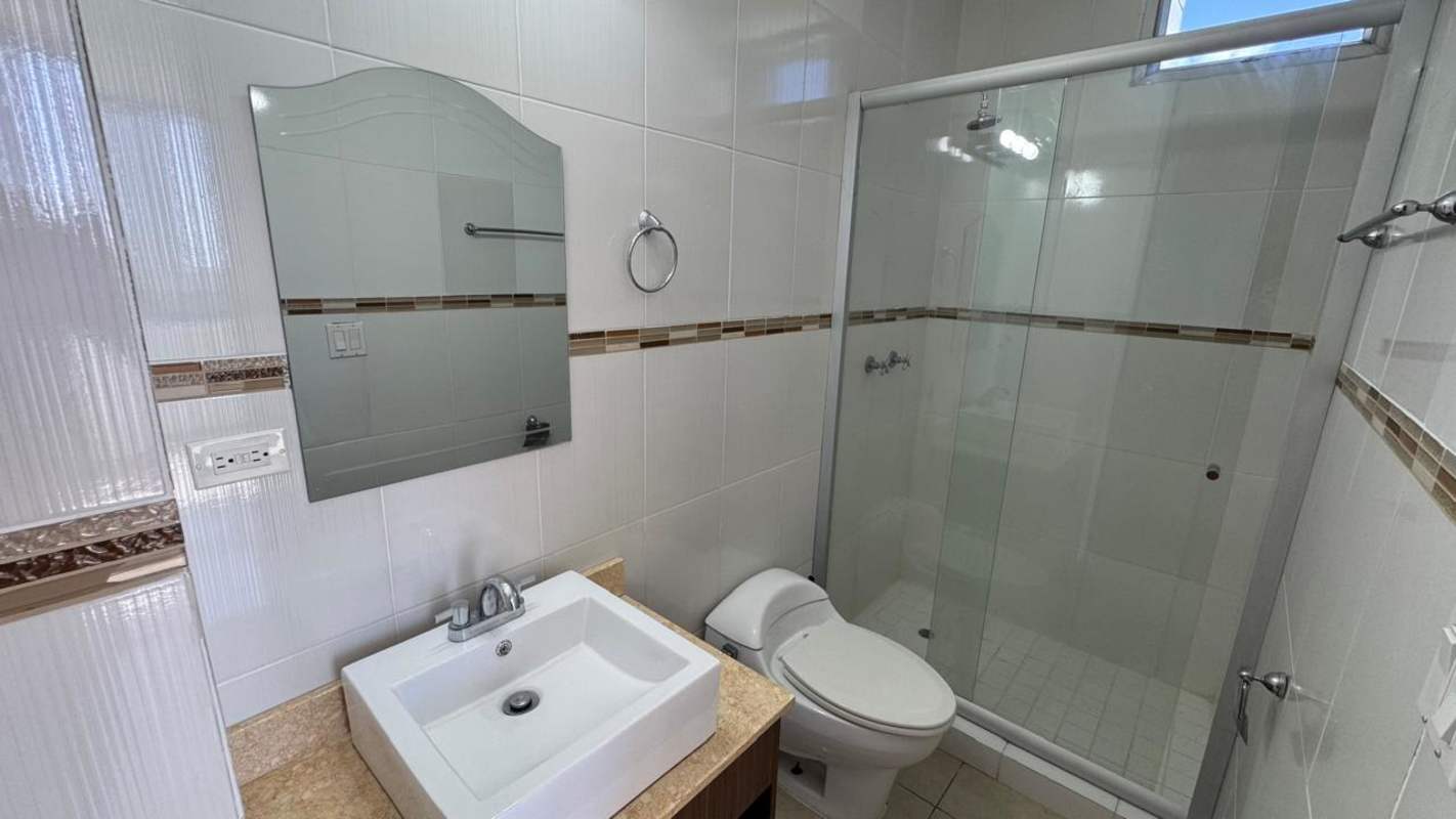 Contemporary bathroom with vessel sink, glass shower, and modern tiles at PH Elevation Tower