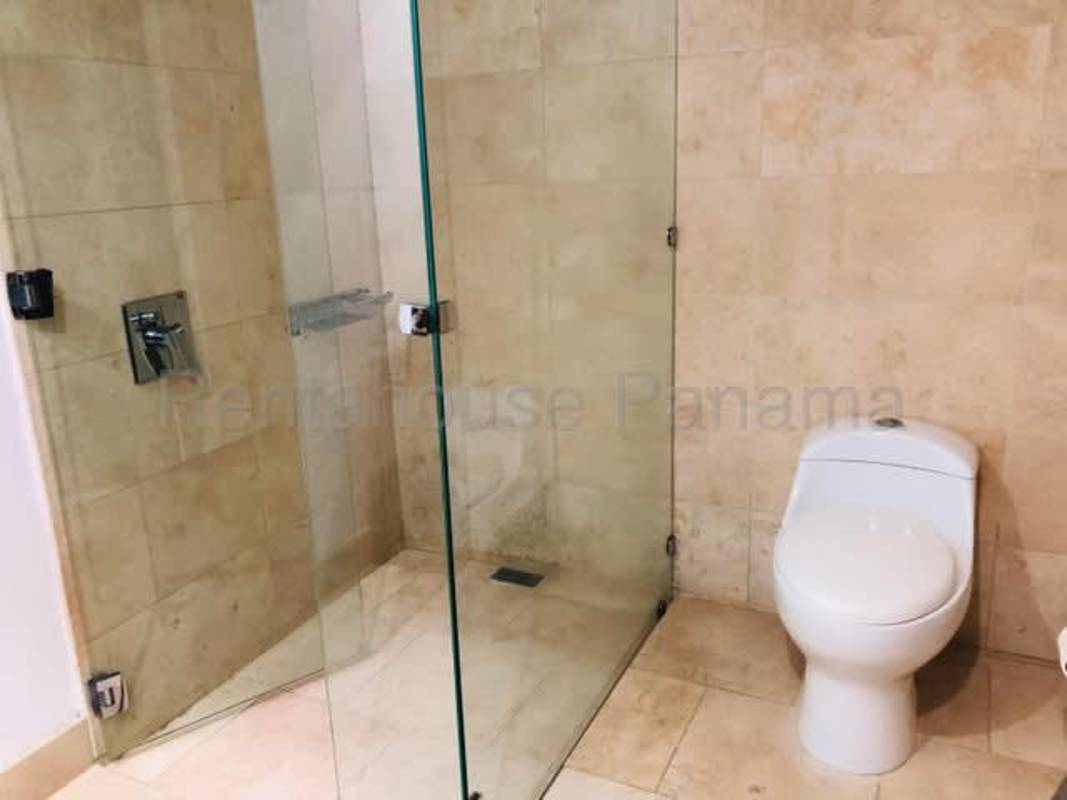 Contemporary bathroom with beige tiles glass shower PH The Ocean Club Punta Pacifica Panama