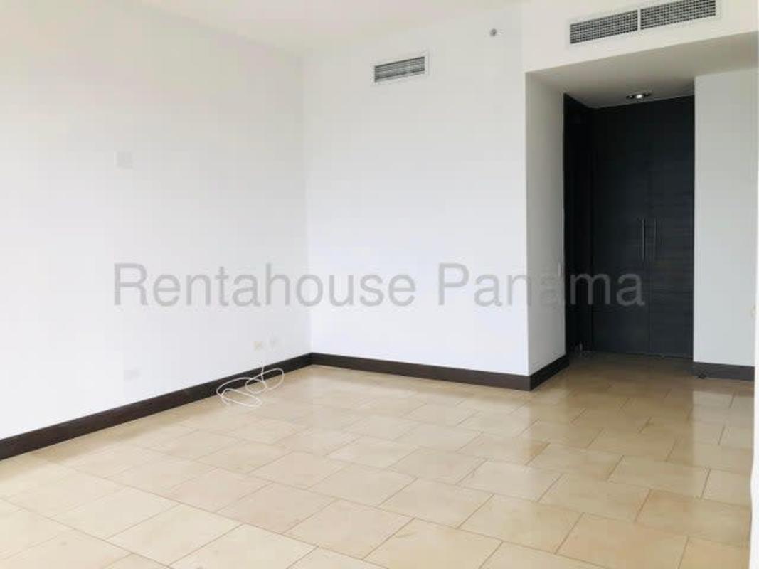 Bedroom with large built-in closet neutral tile flooring PH The Ocean Club Punta Pacifica Panama