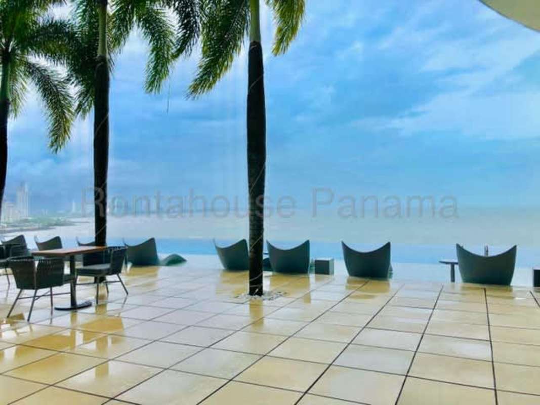 Tropical outdoor terrace oceanfront lounge chairs palm trees PH The Ocean Club Punta Pacifica Panama