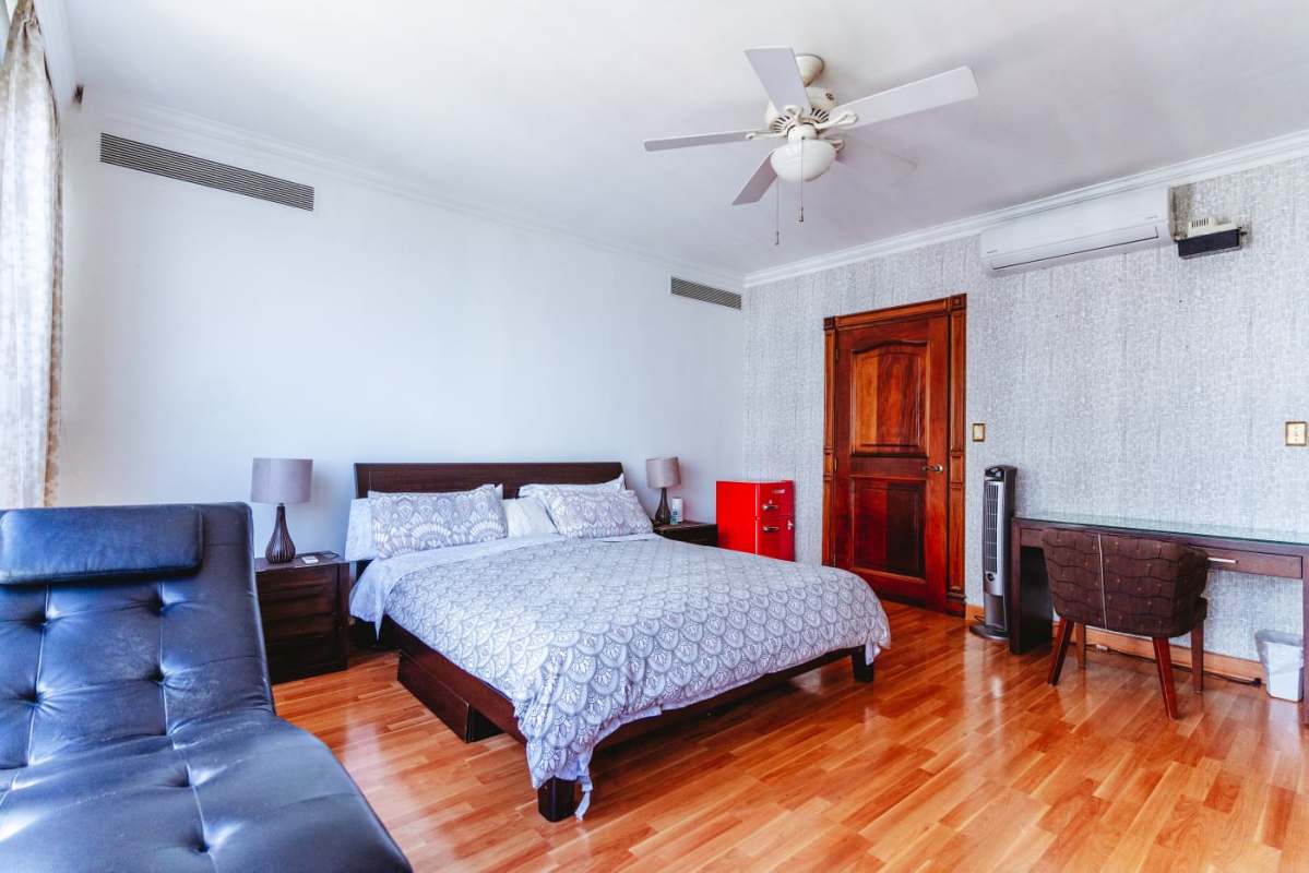 Elegant bedroom suite with city view windows PH Costa del Mar Panama