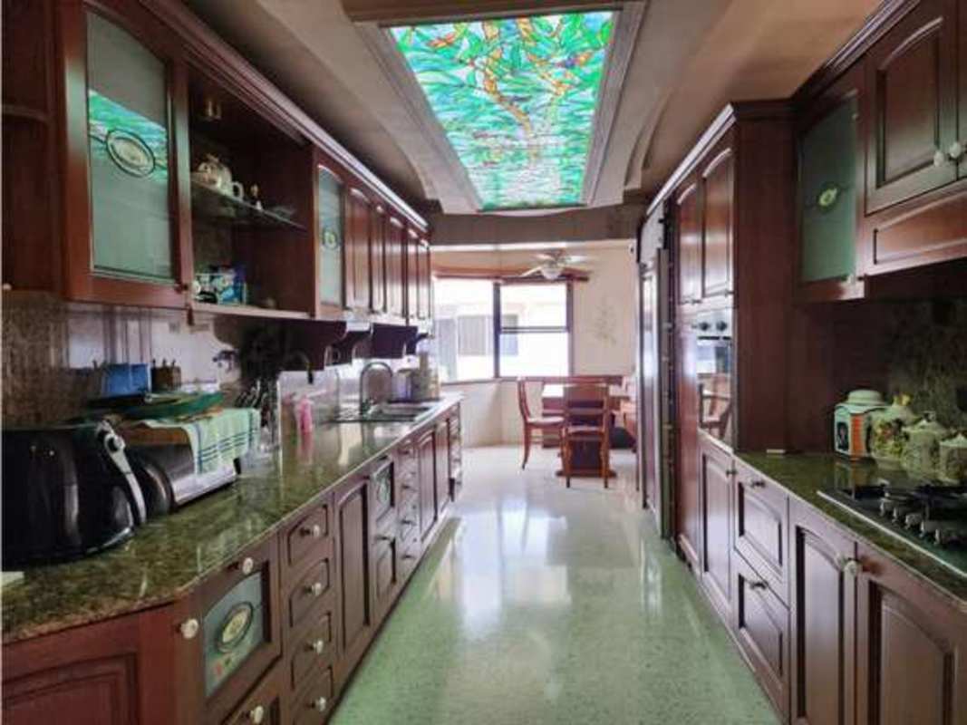 Traditional styled living room with wood panel details and large windows in PH Marina del Rey Coco del Mar Panama City