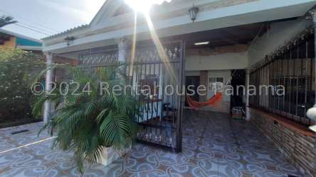 Traditional covered patio with decorative tiles, plants, and hammock space Vacamonte Panama house