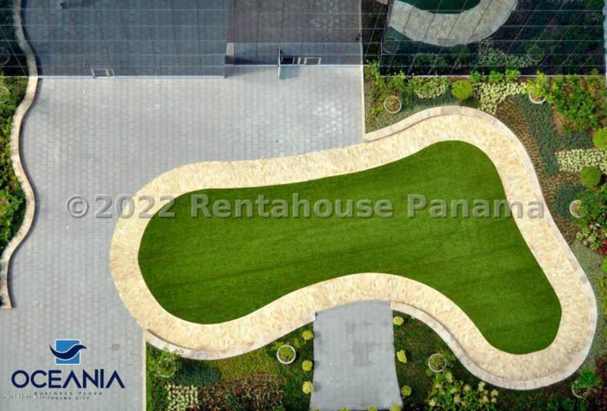 Aerial of Oceania Plaza garden plaza with curved walkways greenery and corporate towers