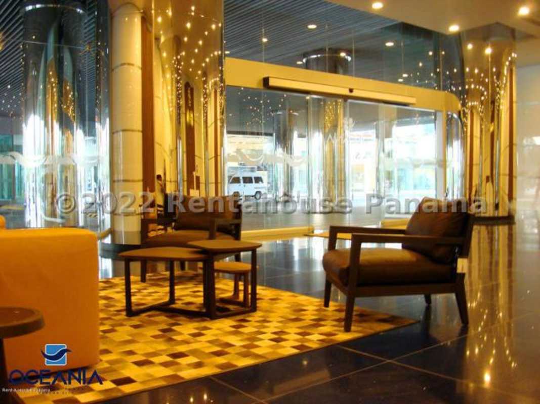 Contemporary restroom featuring double sinks, floating vanity and privacy stall