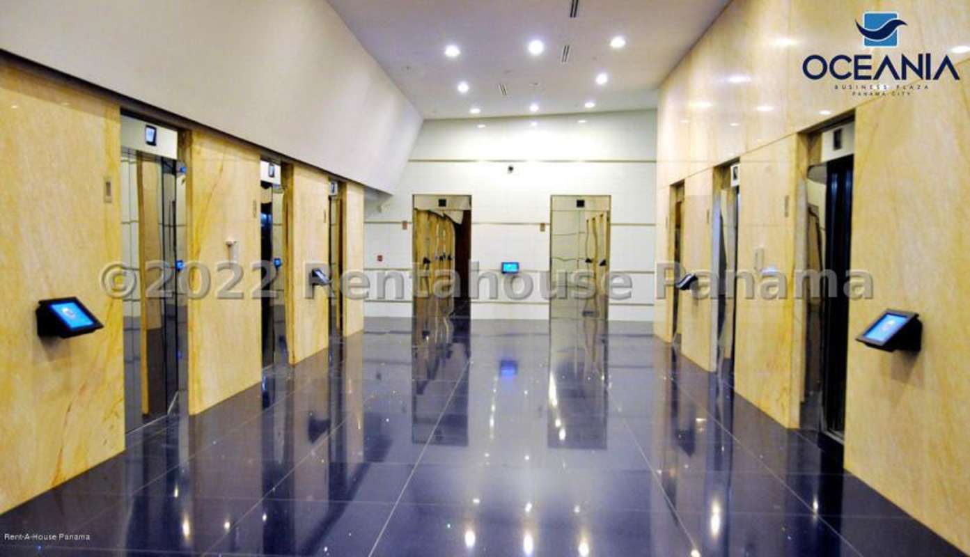 Bright lobby with elevators and polished tile floors