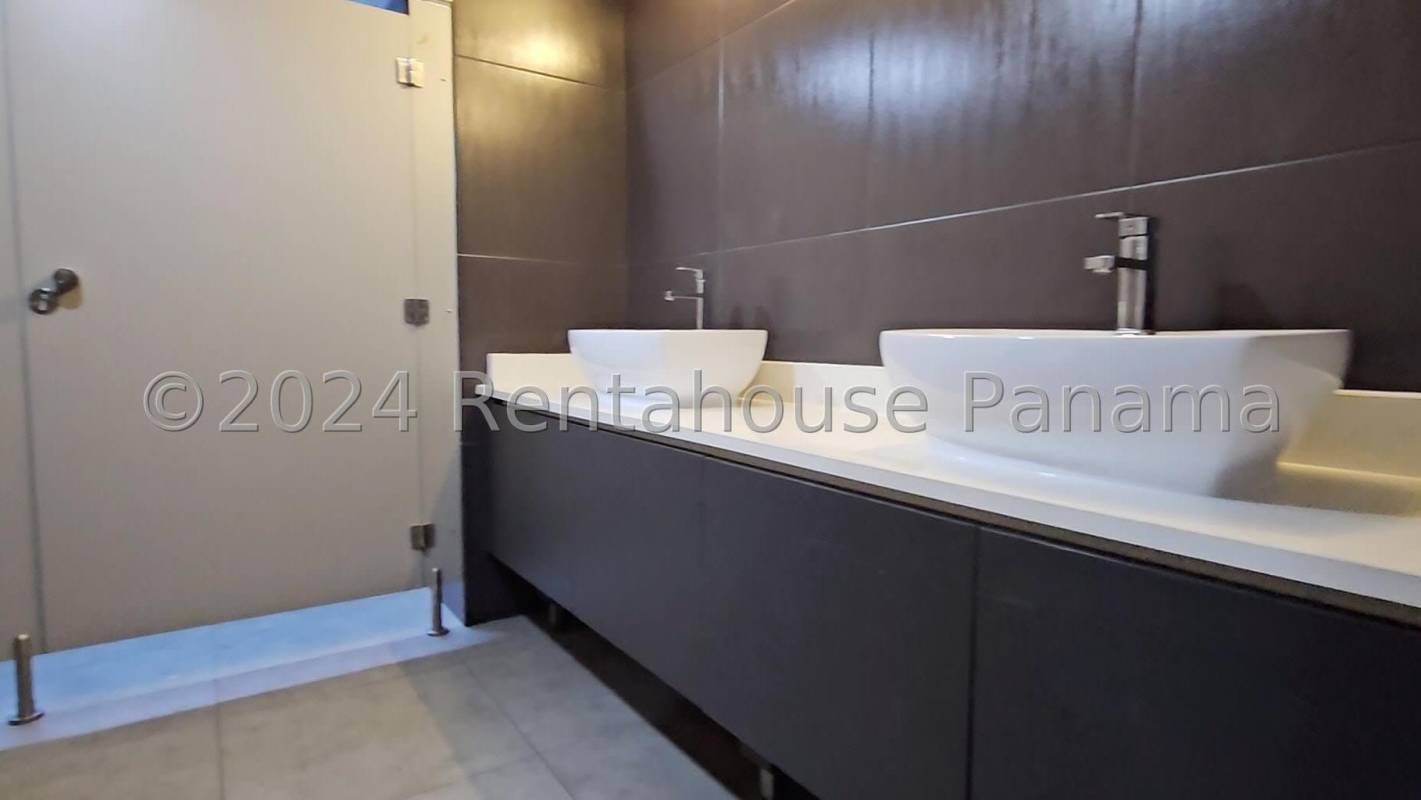 Spacious bright open-plan office area with tile floor and large windows