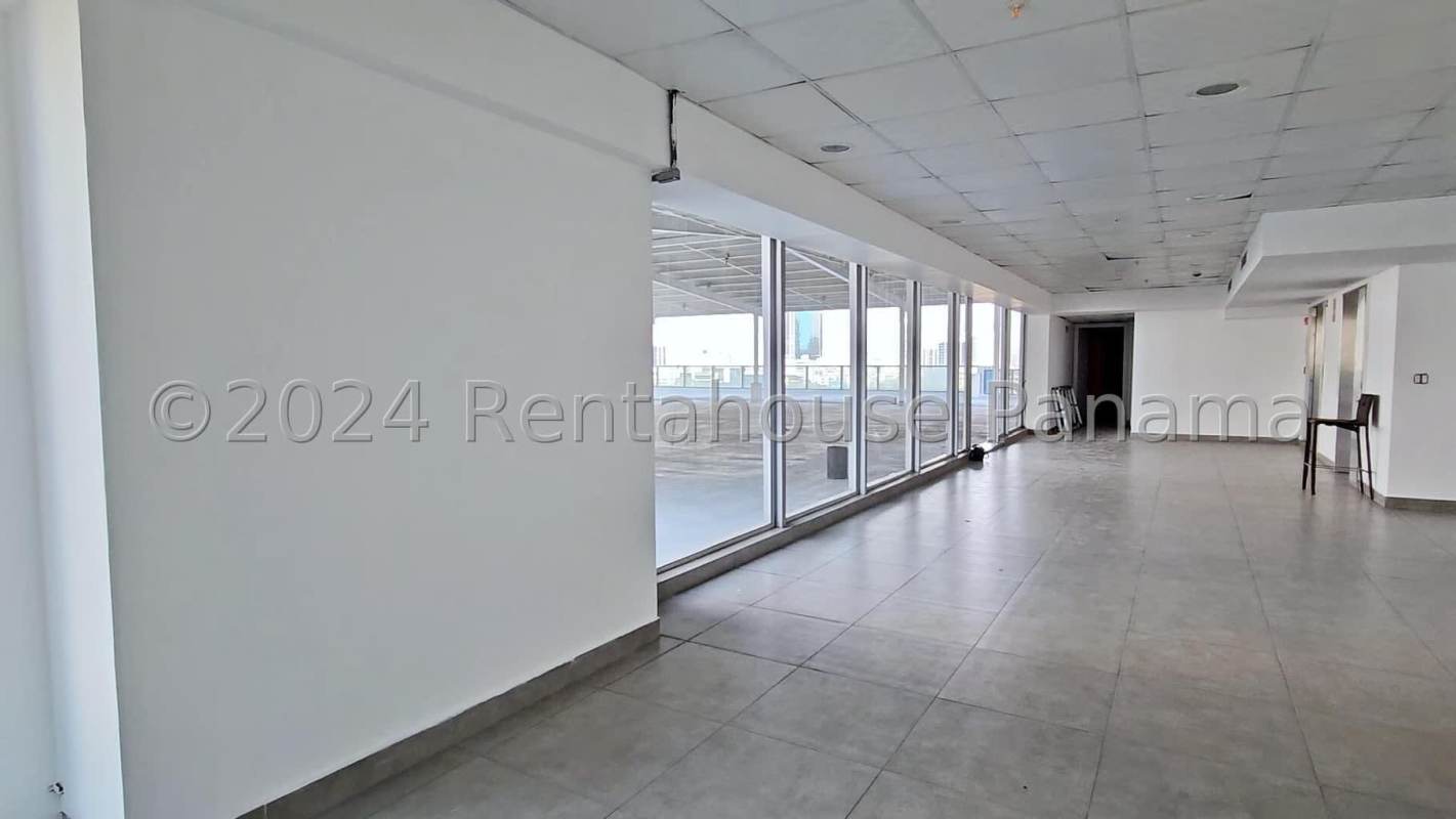 Spacious modern conference room with large windows and skyline backdrop