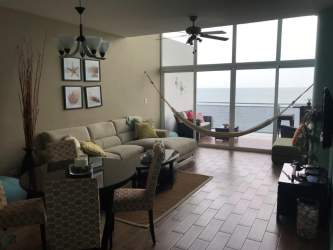 Bright living room with double height windows oceanfront PH Miramar Loft Farallón Panama