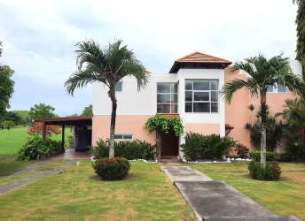 Bright living room with sliding doors to garden, wicker sofa set, ceiling fan in Villas de Decameron Farallon Panama