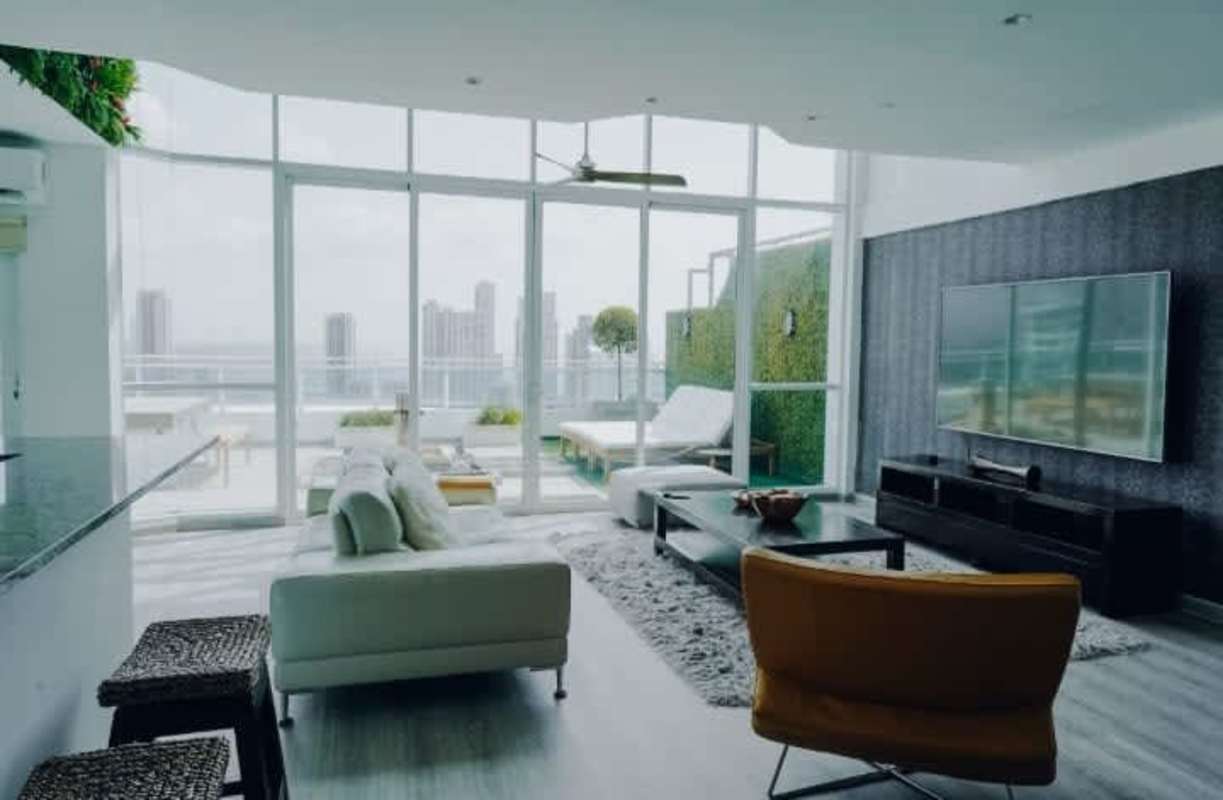 Bright loft living room overlooking Panama City skyline and terrace at PH Premium Tower San Francisco