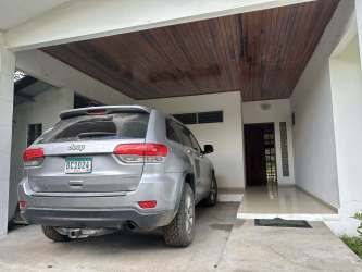 Spacious kitchen with wooden cabinets and tile backsplash in Villa Dora David Panama