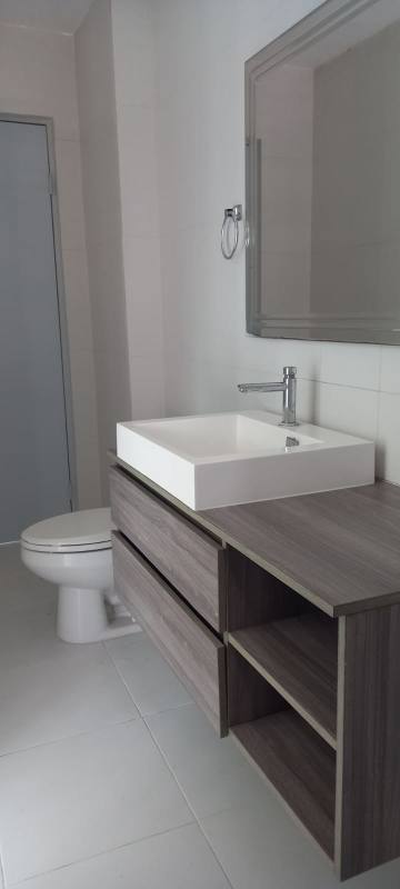 Modern minimalist office bathroom with vessel sink wood vanity and wall mirror Panama