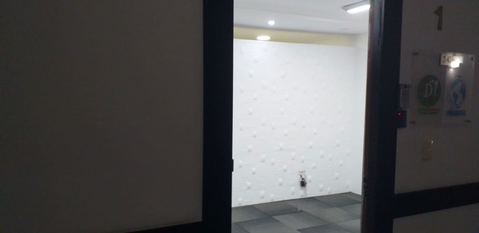 Bright empty office space showing textured white accent wall recessed lighting Panama