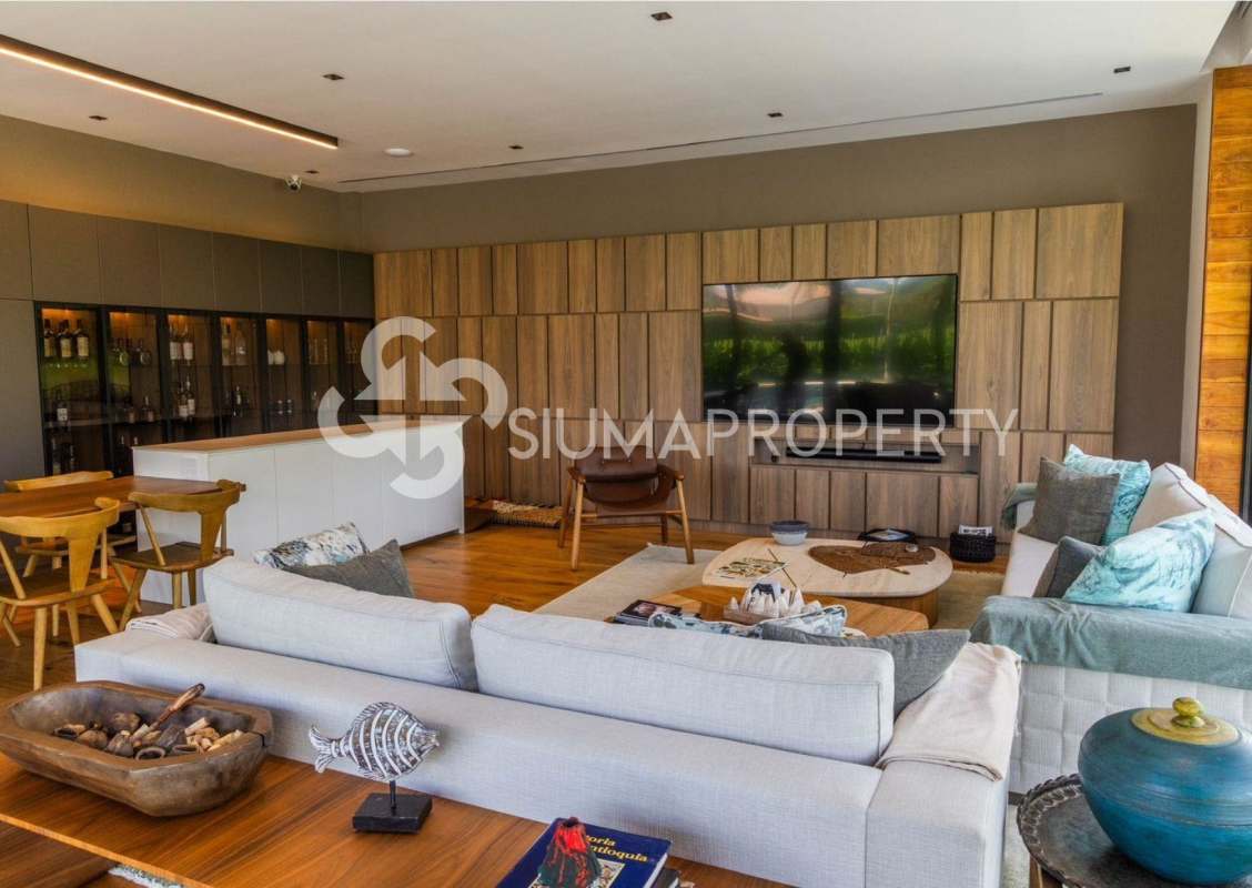 Luxury mansion living room with wood panel walls, built-in bar and large TV in Santa Maria