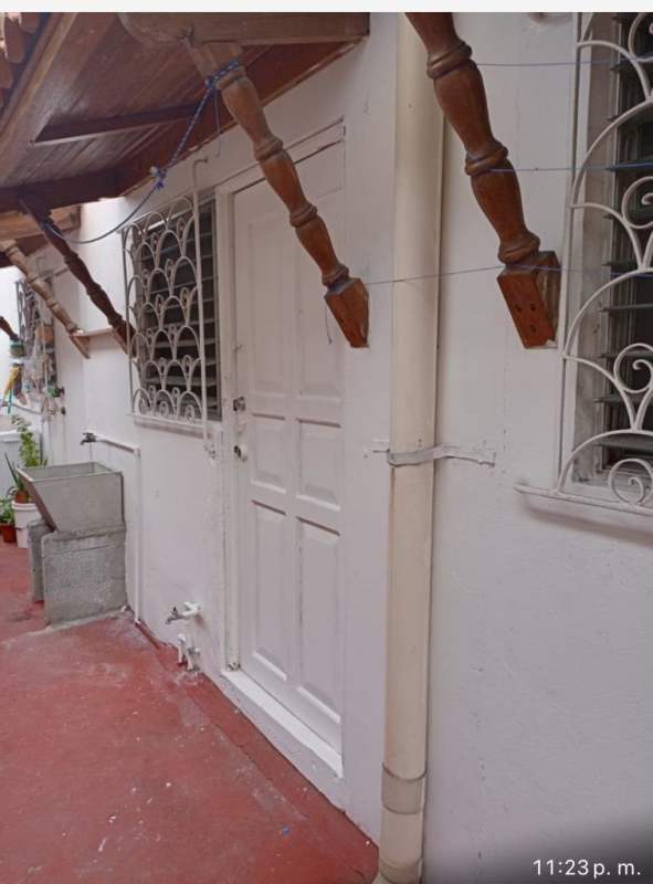 Covered walkway, iron window grills, terra cotta floor at San Antonio room rental